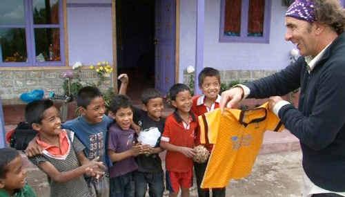 Noah Hutchinson brings looks of delight to the soccer-mad kids in Jambange with a gift of 22 Noosa Eagles football shirts, a kit bag and a soccer. Picture: Contributed