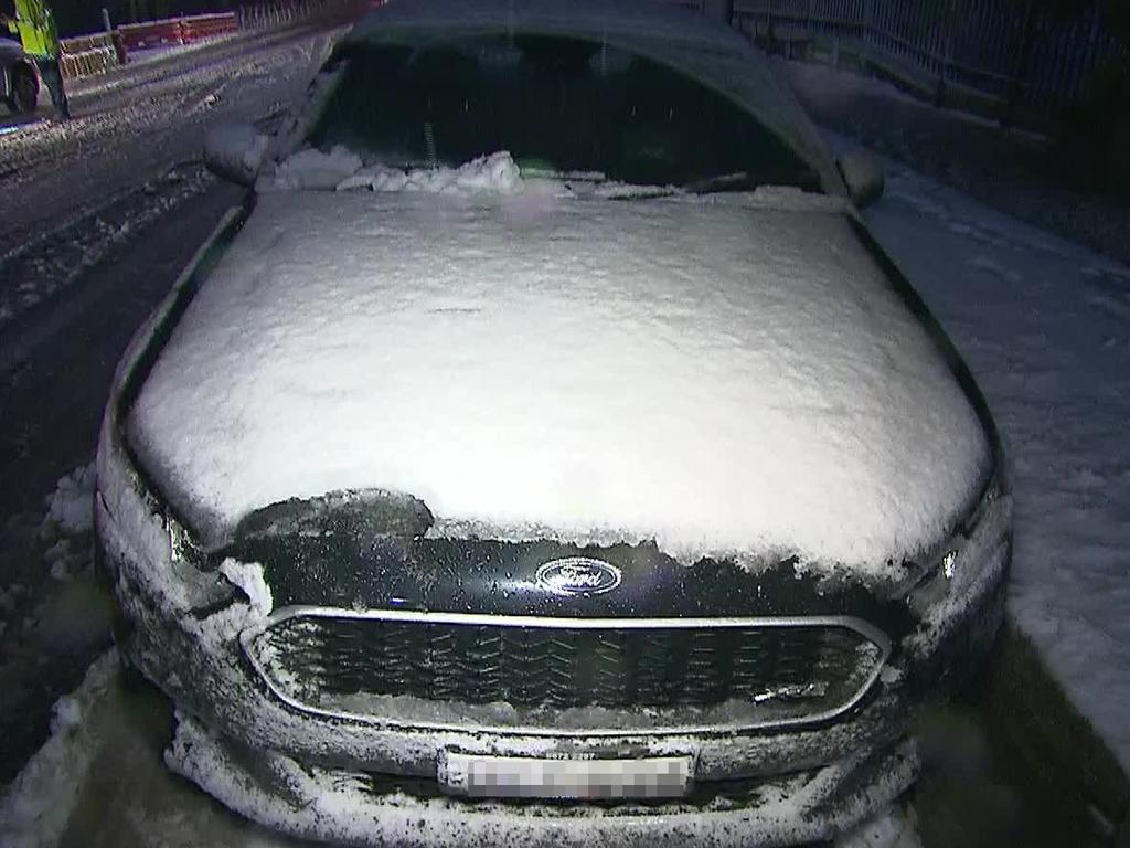 A car is covered in snow at Blackheath, where authorities have warned drivers not to attempt to trip to Sydney. Picture: TNV