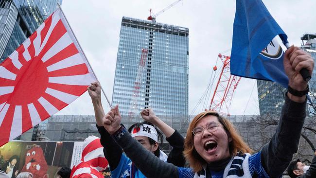 Fans celebrate after Japan's victory over Spain, at the Shibuya Crossing area in Tokyo. Picture: AFP