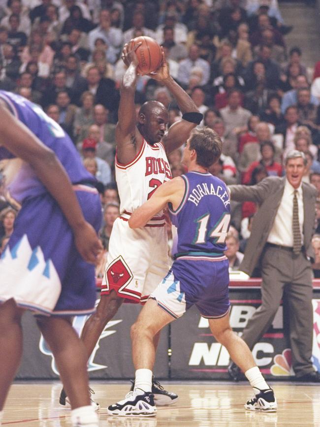 Jerry Sloan watches Jeff Hornacek guard Michael Jordan of the Chicago Bulls duringthe 1997 NBA Finals.