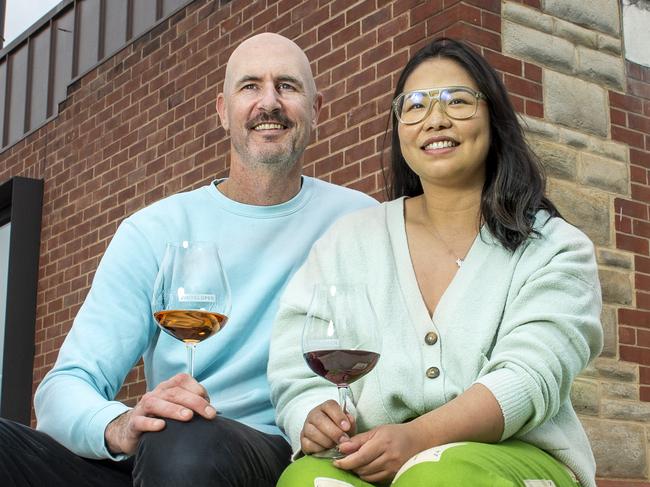 David Bowley and partner Sharon Hong owners of Vinteloper cellar door sit outside in front of the old fire damaged facade with their new copper clad building built on its inside at Lobethall .Tuesday,September,24,2024.Picture Mark Brake