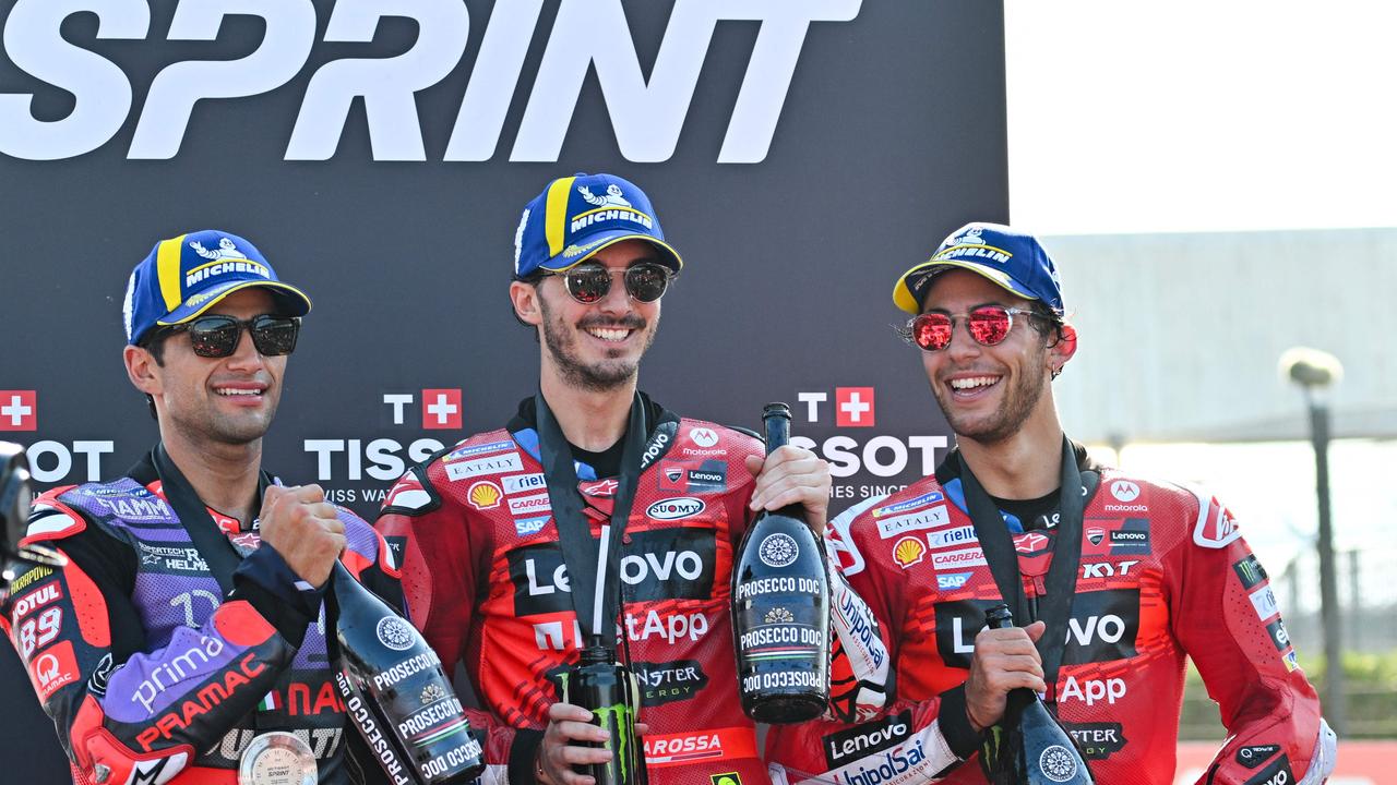 First place Ducati Italian rider Francesco Bagnaia (C), second place Ducati Spanish rider Jorge Martin (L) and third place Ducati Lenovo Team's Italian rider Enea Bastianini celebrate on the podium after the sprint race of the Emilia-Romagna MotoGP Grand Prix at the Misano World Circuit Marco-Simoncelli in Misano Adriatico, on September 21, 2024. (Photo by Andreas SOLARO / AFP)