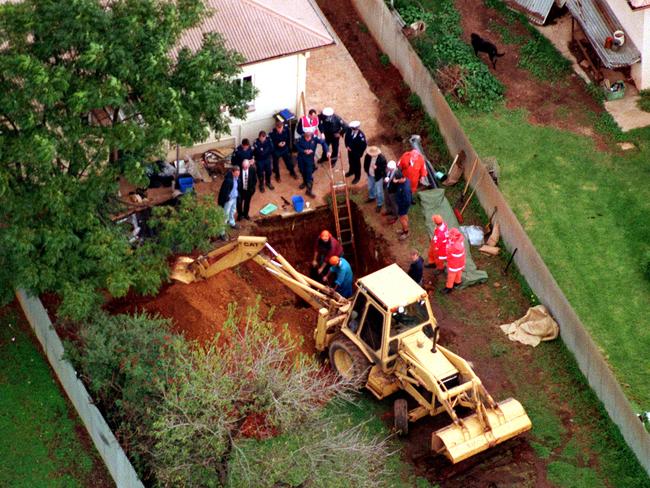 Forensic police examine the backyard at a house on Waterloo Corner Rd in Salisbury North, where victims’ remains were dug up. Picture: Leon Mead