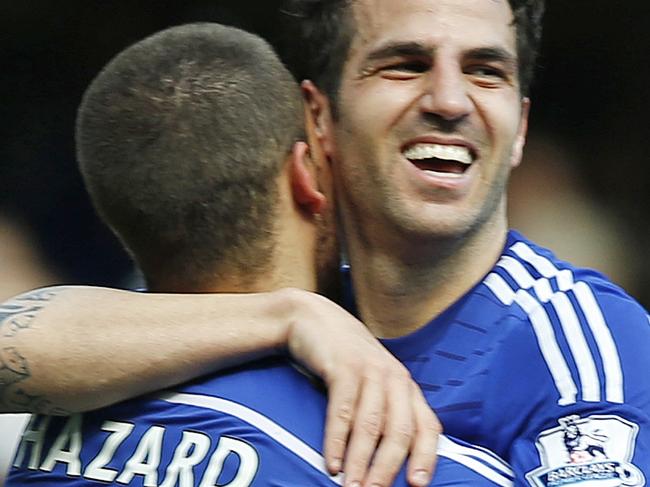 Chelsea's Eden Hazard, left, embraces Cesc Fabregas after the English Premier League soccer match between Chelsea and Crystal Palace at Stamford Bridge stadium in London, Sunday, May 3, 2015. Chelsea won the match 1-0 to secure Premier League title with 3 games to spare. (AP Photo/Alastair Grant)