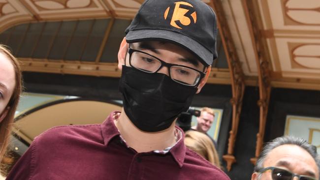 Yi Zheng (centre) leaves the Downing Centre Court in Sydney, Thursday 21 March, 2019. Former AMP contractor Yi Zheng has pleaded guilty to downloading customer details without authorisation and sending them to his personal email address. (AAP Image/Peter Rae) NO ARCHIVING