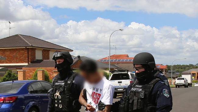 A man is led away by police. Picture: NSW Police