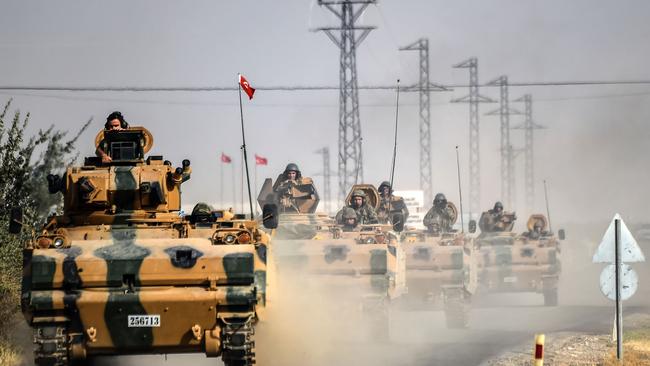 Turkish Army tanks drive to the Syrian Turkish border town of Jarabulus. Picture: AFP