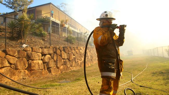 A firefighter works against a bushfire in Bonogin. Picture by Scott Fletcher