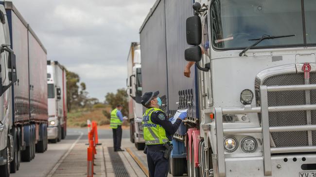 Police at a checkpoint on the Victoria-South Australia border. Picture NewsWire / Darren Seiler.