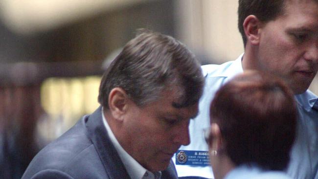 Bandali Michael Debs is led into the Supreme Court for a sentencing hearing in 2003. Picture: Kelly Barnes