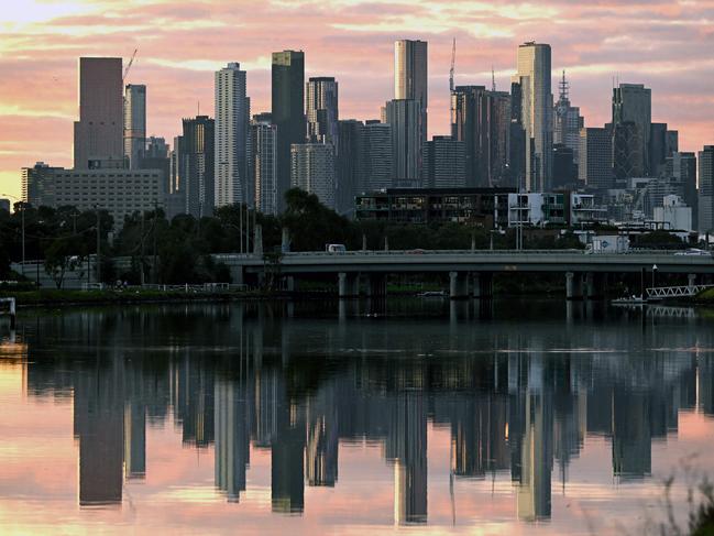 The Melbourne skyline in reflected in the Maribyrnong River in the early morning light on April 18, 2023. - Melbourne has officially become Australia's most populous city after an adjustment to the city boundaries which saw its population jump to 4,875,400, almost 19,000 more than Sydney, according to Australia's Bureau of Statistics. (Photo by William WEST / AFP)