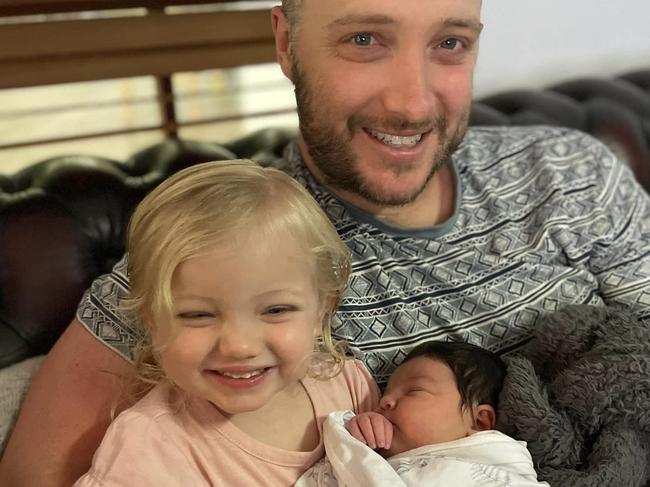 Mia Riley, 5 weeks old, who was killed in an horrific incident at Moruya involving two rottweilers. Pictured with her older sister Layla and her dad Tom Riley. Picture: Facebook