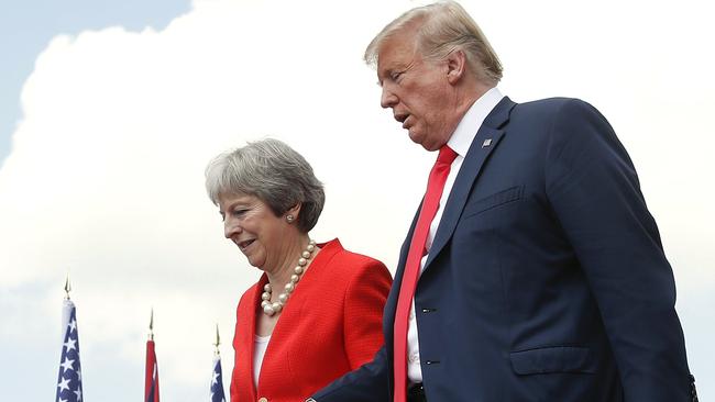 President Donald Trump and British Prime Minister Theresa May hold hands at the conclusion of their joint news conference at Chequers, in Buckinghamshire on Friday. Picture: AP/Pablo Martinez Monsivais