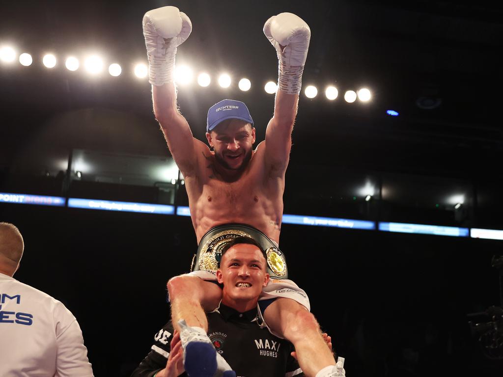 Maxi Hughes celebrates his win over Kid Galahad on the shoulders of two-time world champion and training partner, Josh Warrington in September. Picture: Nathan Stirk/Getty Images