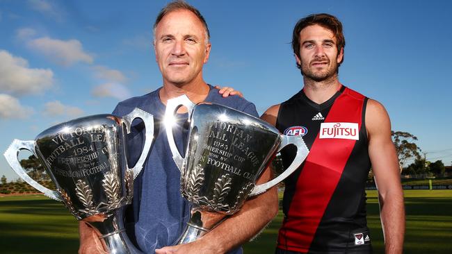 Tim Watson with two Bombers premiership cups and son Jobe. Picture: Michael Klein