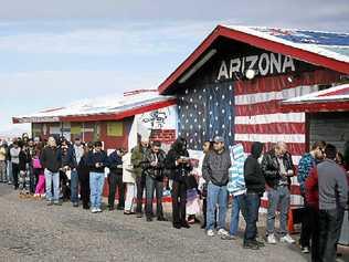 DREAM CHASERS: Thousands wait in line to buy Powerball lottery tickets in America. Picture: John Locher