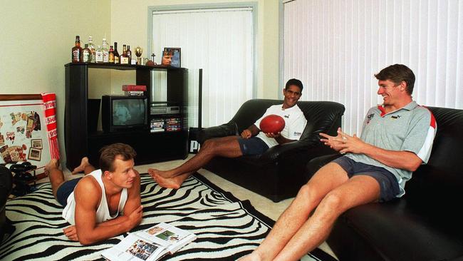 New Crows coach Matthew Nicks (on floor) with Swans teammates and housemates Michael O’Loughlin and Simon Arnott in their apartment in 1998.