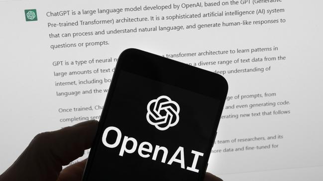 FILE - The OpenAI logo is seen on a mobile phone in front of a computer screen which displays output from ChatGPT, March 21, 2023, in Boston. (AP Photo/Michael Dwyer, File)