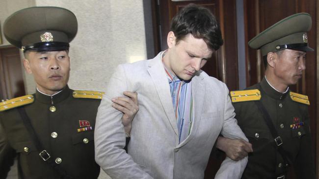 Warmbier is escorted at the Supreme Court in Pyongyang. Picture: AP