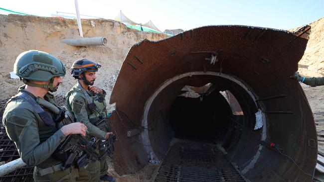 Soldiers stand at the entrance of a tunnel that Hamas reportedly used to attack Israel through the Erez border crossing on October 7.