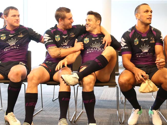 Cameron Munster and Cooper Cronk talk as they pose for their team photo.