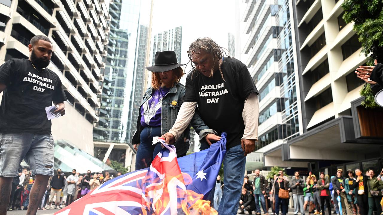 Protesters burned the flags while protesting the monarchy on the national Day of Mourning. Picture: NCA NewsWire / Dan Peled