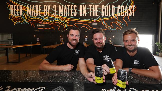 Dan Norris, Michael "Govs" McGovern, and Eddie Oldfield toast their success. Picture Glenn Hampson.