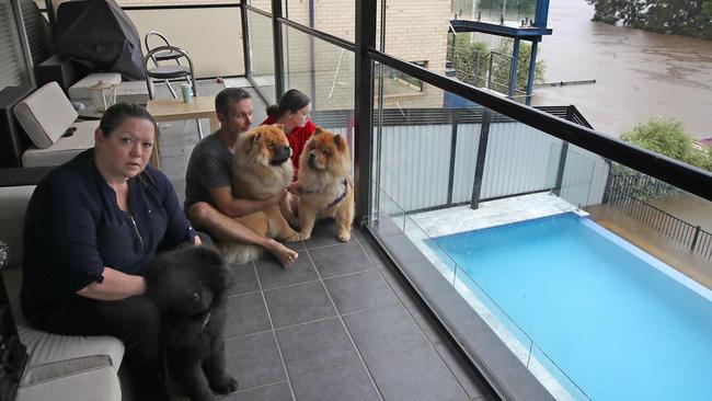 Sydney continues to be drenched in heavy rains causing flooding in local areas and the Warragamba Dam to overflow, sending millions of litres of water down the Nepean River to low lying areas like Emu Plains. Janet Lloyd and her family watch as the floods waters rise at their Bellevue Rd home in Regentville. Picture: Toby Zerna