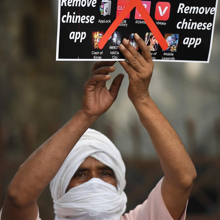 A member of the Working Journalist of India (WJI) holds a placard urging citizens to remove Chinese apps. India has just banned TikTok. Picture: Prakash Sing/AFP