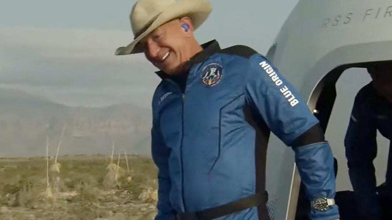 A jubilant Bezos exiting the capsule after returning from space. Yeah, that’s a cowboy hat. Picture: Blue Origin/AFP