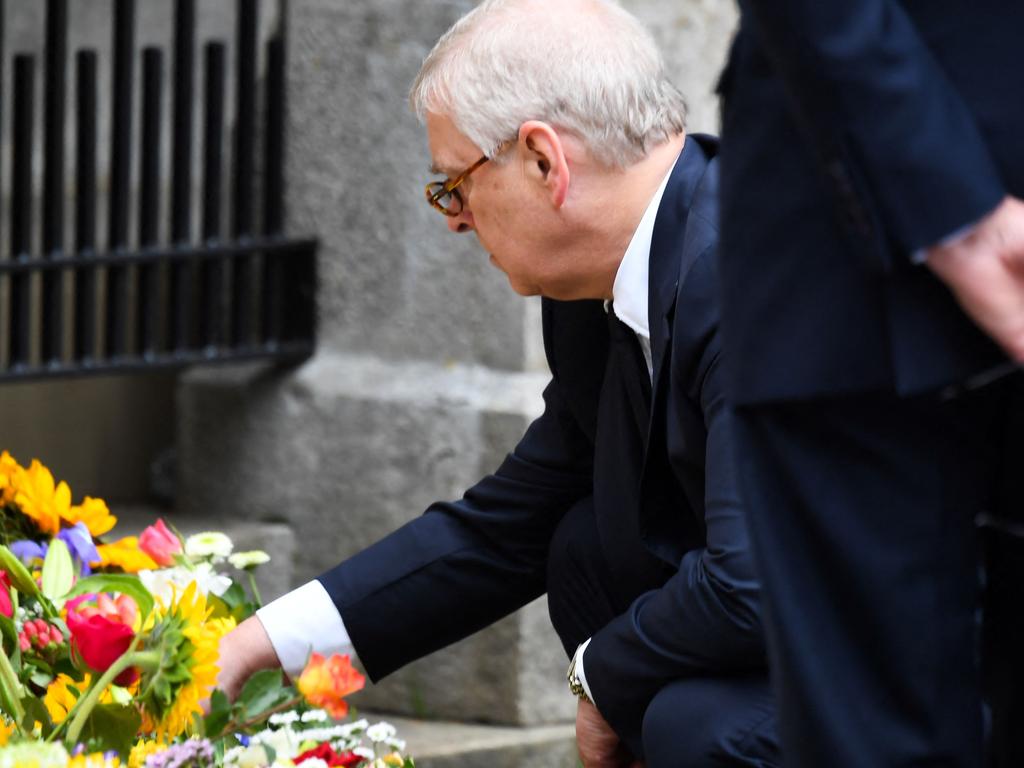 Prince Andrew joined his family to look at the many tributes to his late mother. Picture: AFP