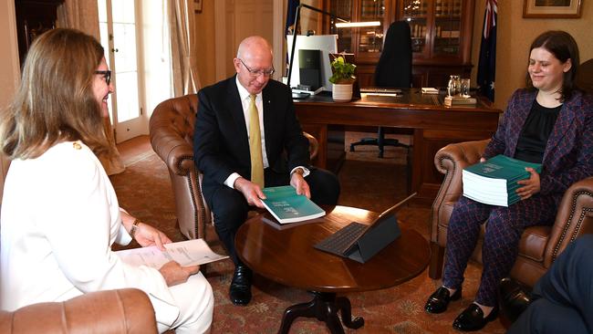 Governor-General David Hurley receives the final report of the Royal Commission into Aged Care Quality and Safety from commissioner Lynelle Briggs, left, and acting official secretary Sara Samios in Sydney on Friday. Picture: AAP