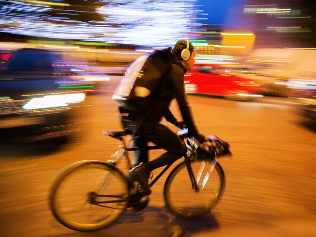 Paris France - October 19 2016: unidentified cycle courier in Paris at night shown in motion blur. Bicycle messengers are most often found in the central business districts of metropolitan areas