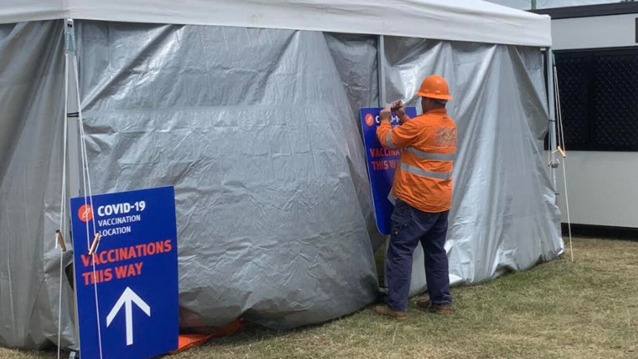 Workers setting up a freight vaccination stop near the Queensland-New South Wales border. Picture: Greg Stolz