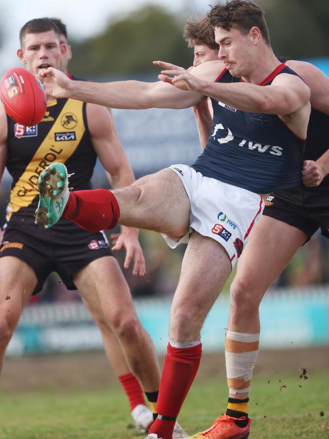 Harry Boyd kicks under pressure against Glenelg at the Bay in Round 16. Picture: Cory Sutton/SANFL