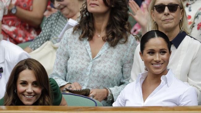 Royals Kate Middleton (left) and Meghan Markle take in the match. Picture: AP