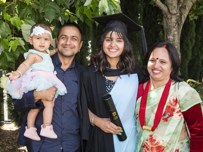 Graduate Santoshi Dhungana with family Bikash Poudel holding Saadhvi Poudel and mum Bindu Dhungana at a UniSQ graduation ceremony at Empire Theatres, Tuesday, October 31, 2023. Picture: Kevin Farmer