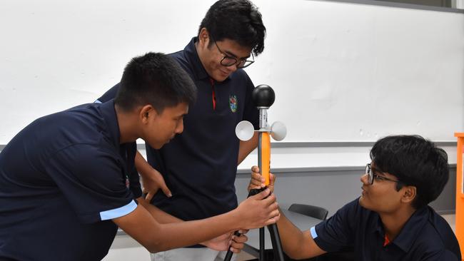 Darwin High School students Monishi Rangchak Tripura, Pothik Vincent Mondol, and Mohammad Niyaz Hasan have devised a strategy to cool rooms cheaply through apparent temperature optimisation. Picture: Sierra Haigh