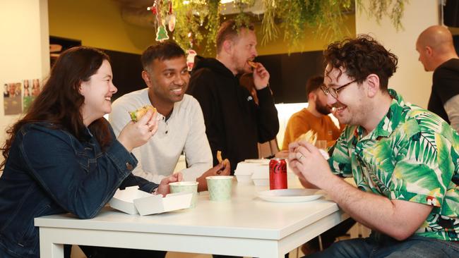 Finder employees in Sydney, Elise Stitt, Raj Lal and Tim Bennett enjoy a free lunch as part of an effort to get them into the office. Picture: John Feder