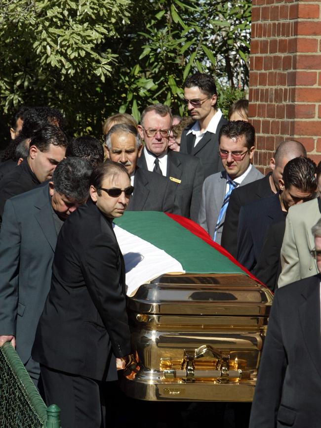 Radev’s body is carried from his funeral in a gold casket.