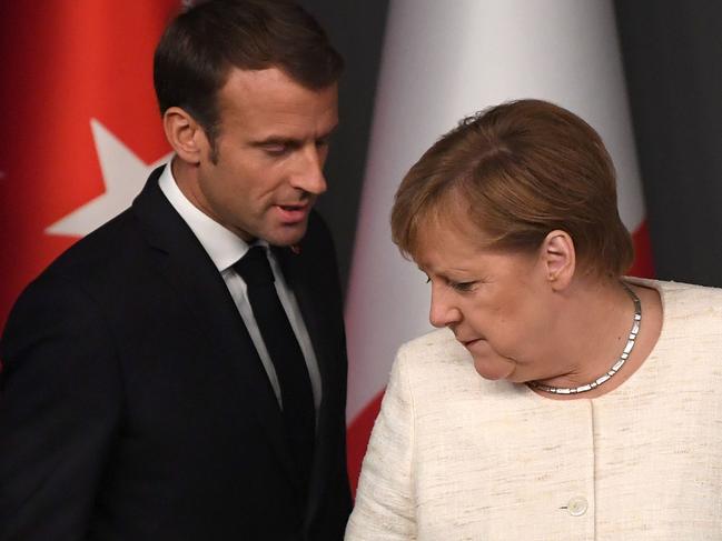 French President Emmanuel Macron (L) and German Chancellor Angela Merkel attend to a conference as part of a summit called to attempt to find a lasting political solution to the civil war in Syria which has claimed in excess of 350 000 lives, at Vahdettin Mansion in Istanbul, on October 27, 2018. - The leaders of Turkey, Russia, France and Germany are set to meet in Istanbul to try to find a lasting political solution to the Syrian civil war and salvage a fragile ceasefire in a rebel-held northern province. (Photo by OZAN KOSE / AFP)