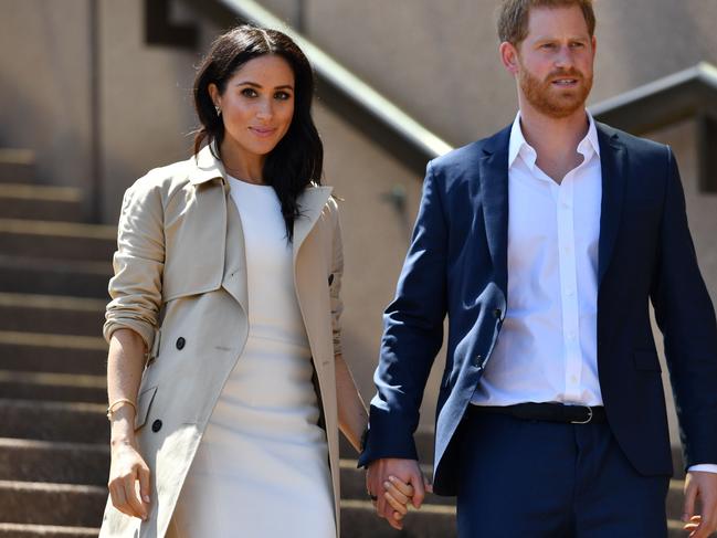 Britain's Prince Harry and his wife Meghan walk down the stairs of the Opera House during their 2018 tour. Picture: AFP