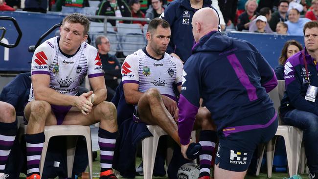 Melbourne's Cameron Smith on the bench after leaving the field with an ankle injury against South Sydney. Picture: Brett Costello