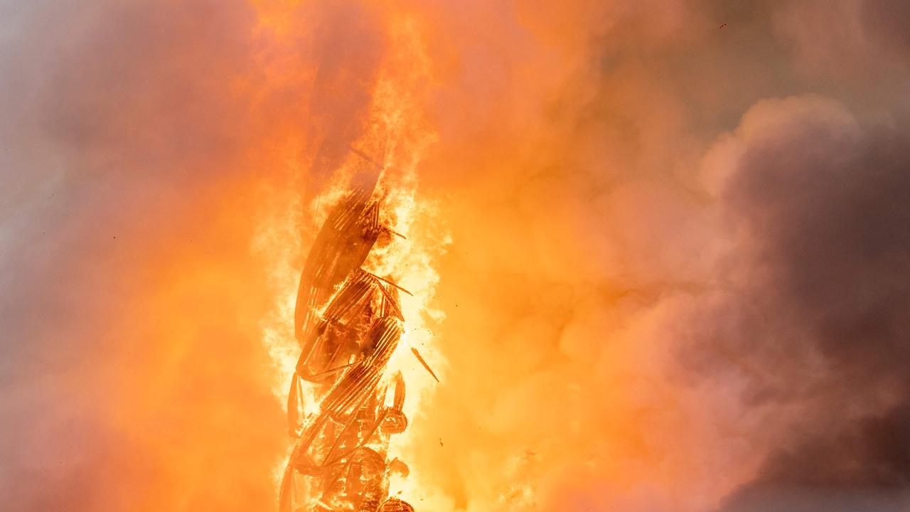 Plumes of smoke billow from the Dragon Spire of the old stock exchange. (Photo by Ida Marie Odgaard / Ritzau Scanpix / AFP) / Denmark OUT