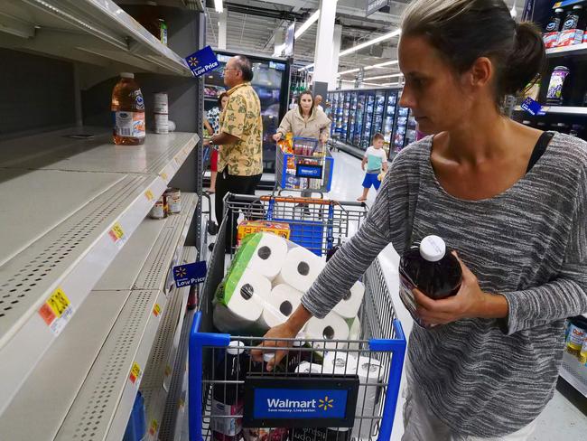 Erica McMillan stocks up with what's left on the shelves at Walmart in Oahu, Hawaii. Picture: AFP