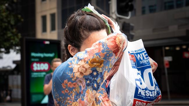 Chantelle Elizabeth Carrington tries tio hide her face as she walks out of court at Downing Centre today. Photographer: Tom Parrish