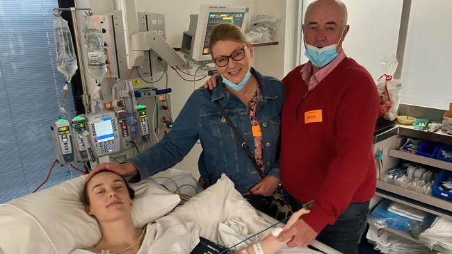 Jockey Laura Lafferty recovers in hospital with her parents Peter and Sharon by her side. Picture: Supplied