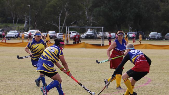 Leigh Robinson Kate Dilger (Townsville) battle Jane Hayes and Tracey Elphick (Brisbane) in the 2021 Queensland Hockey Women’s Masters Championships