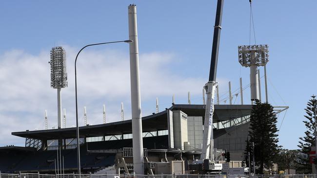 The first of the four light towers come down at Football on Tuesday. Picture Sarah Reed