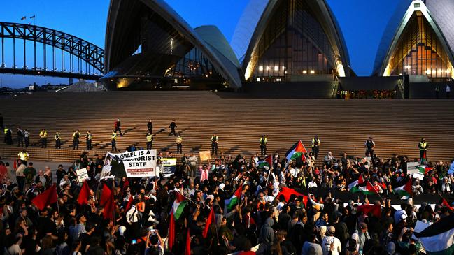 Participants of a Free Palestine rally react outside Sydney Opera House in Sydney, Monday, October 9, 2023. Israel has pounded the Palestinian enclave of Gaza, killing hundreds of people in retaliation for one of the bloodiest attacks in its history when Islamist group Hamas killed 700 Israelis and abducted dozens more. (AAP Image/Dean Lewins) NO ARCHIVING